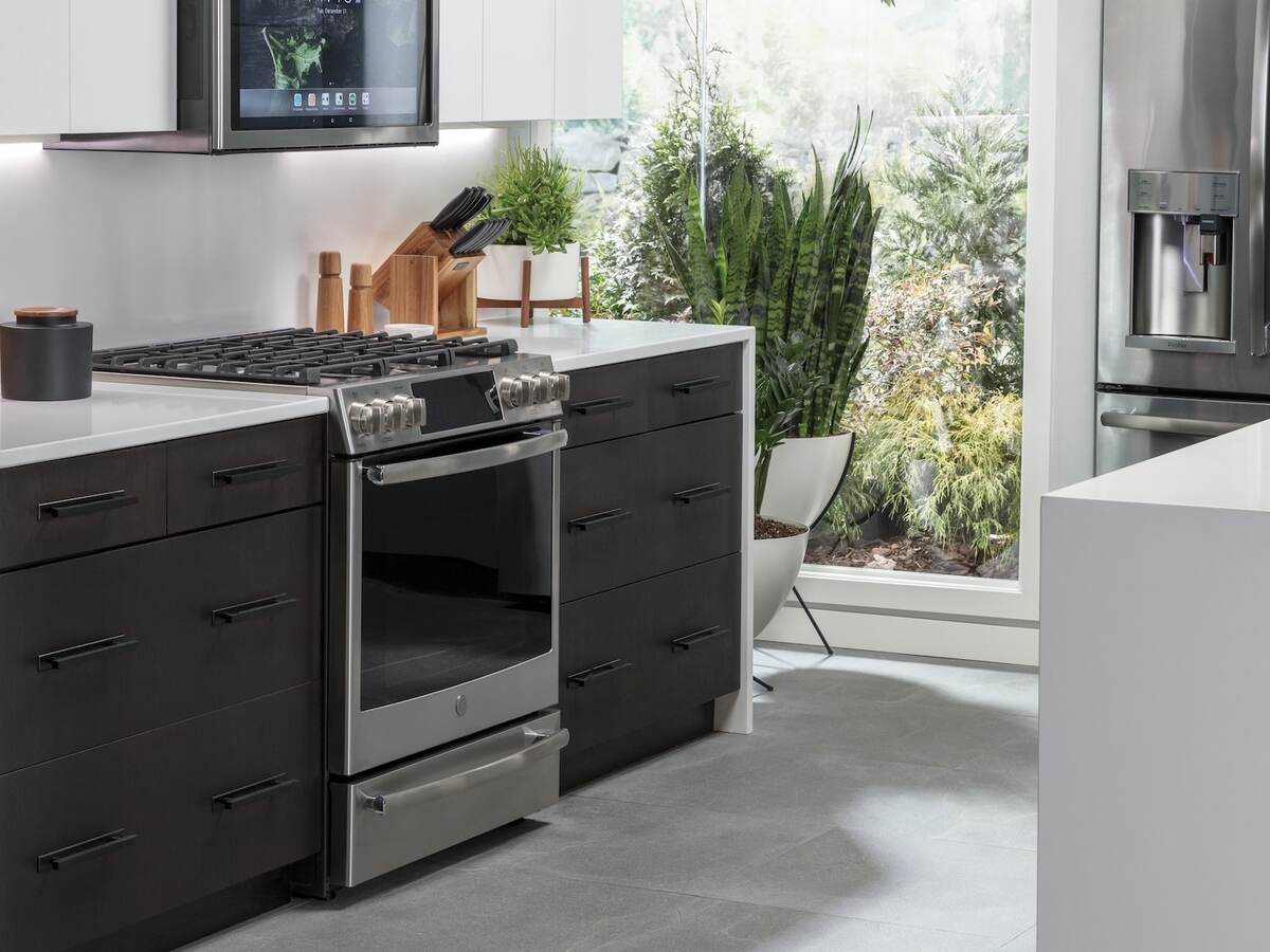 A picture perfect kitchen filled with GE IoT connected appliances, microwave, stove, refrigerator and dishwasher